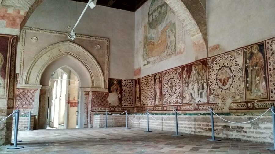 From Seville: Italica Roman City & Medieval Monastery Tour - The amphitheater, gladiator passages, and the Dragonpit effect