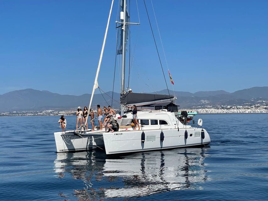 Marbella: Group Dolphin Watching Catamaran Tour with Snacks - When the Wind Helps: Sails Up and Cooler Air on Deck