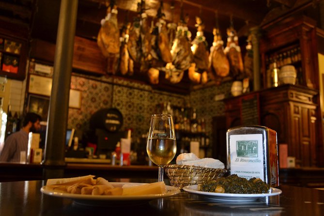 Sevilla Food Tour: Tapas, Wine, History & Traditions - Los Soportales: Chicharrones, montadito, and Cruzcampo from the barrel