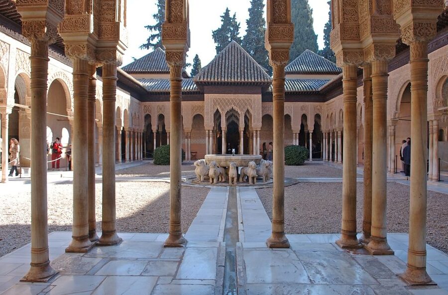 Seville: Alhambra Day Trip with Guide & Nasrid Palaces Entry - Entering the Alhambra with reserved access, a guide, and an audio system