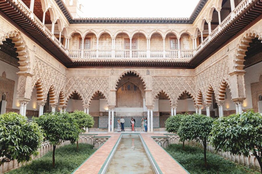 Seville: Guided Walking Tour with Alcazar & Cathedral Access - Inside the Royal Alcazar: Moorish rooms and gardens with context