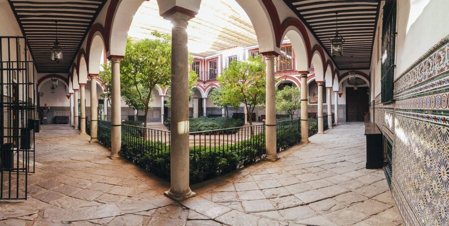 Seville: Hospital de los Venerables Ticket with Audio Guide - The traditional Sevillian patio and its wooden gates