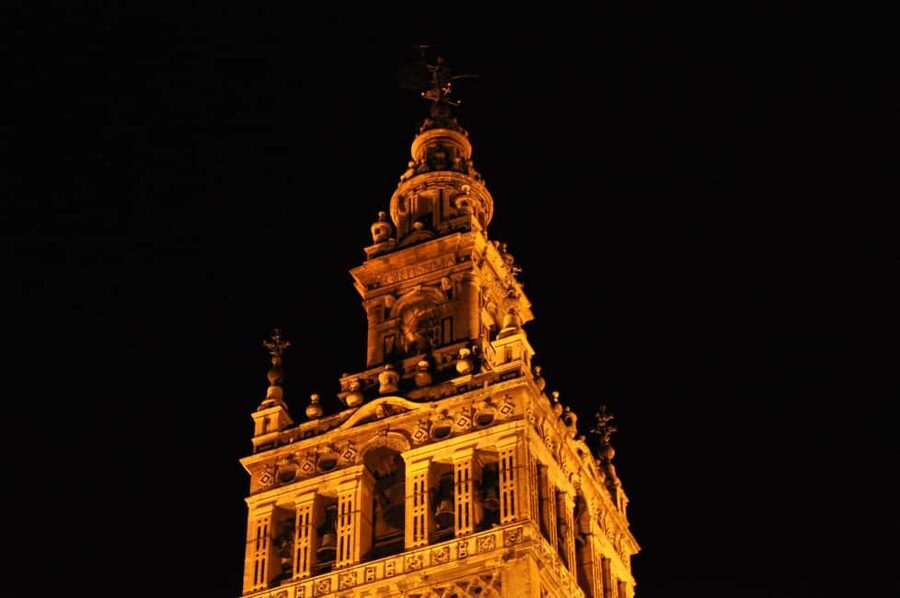 Seville Night Tour A Must See - Banco de España and the Cathedral core, seen the way locals read it